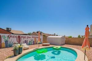 a swimming pool with an umbrella and a fence with a mural at Private Pool & Fully Fenced Yard Near Mntn Park in Glendale +87 photos