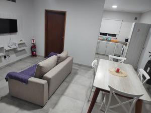 a living room with a couch and a table at Alojamientobruisa in Lobos