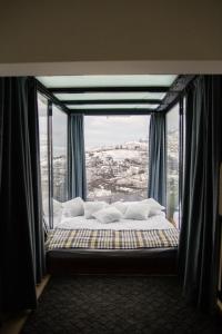 a bed in a room with a large window at Lazord's Ev Bungalow in Geçit