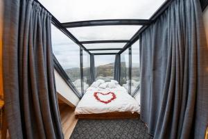 a room with a bed with a heart on it at Lazord's Ev Bungalow in Geçit