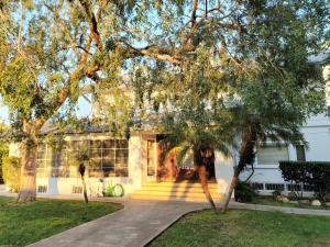 a white house with trees in front of it at Orange Drive Hostel in Los Angeles