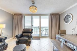 a living room with a table and chairs and a balcony at Pelican Beach Resort 504 in Destin