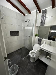 a bathroom with a shower and a toilet and a sink at Apartamento cerca al metro y viva envigado in Itagüí +15 photos