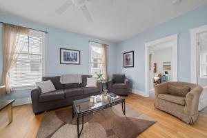 a living room with a couch and a table at The Violet - 42 Meadow View in Cherry Valley