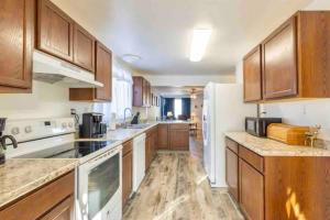 a kitchen with wooden cabinets and a white refrigerator at Bo's Copper City Charmer, easy Freeway Access, open floorplan in Butte