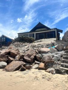 a pile of rocks on the beach in front of a building at Angelita sobre playa in Aguas Dulces