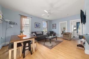 a living room with a couch and a table at The Violet - 42 Meadow View in Cherry Valley