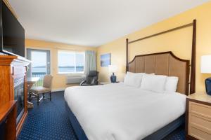 a hotel room with a bed and a television at Fireside Inn, Ocean's Edge in Belfast