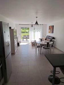 a kitchen and dining room with a table and chairs at Le charme tranquille in Neuville-sur-Seine +17 photos