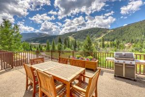 a patio with a table and chairs and a grill at Hidden River Lodge 5975 in Keystone