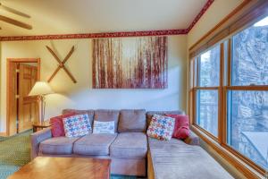 a living room with a couch and a window at Hidden River Lodge 5975 in Keystone