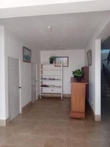 a hallway with a staircase and a dresser in a room at Hostal Lobitos in Cerro Azul