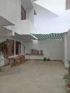 a room with a table and chairs in a building at Hostal Lobitos in Cerro Azul