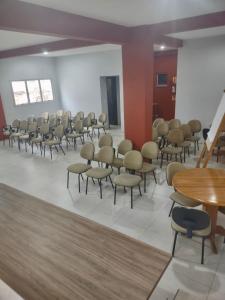 a waiting room with chairs and tables in a building at Goldmen Business Criciúma in Criciúma