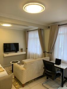 a living room with a couch and a television at Chisplace in Nakuru