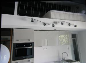 a kitchen with a sink and a stove top oven at Villa ou studio indépendant PISCINE sans vis à vis in Mudaison
