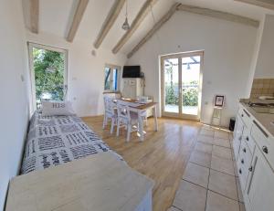 a kitchen with a table and a dining room at Apartments Ivas in Zambratija