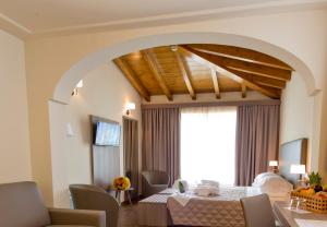 a living room with a table and a dining room at Villa Carolina Resort in Castelletto d'Orba
