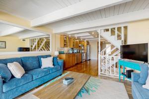 a living room with a blue couch and a tv at Ocean Colony 3 in Ocean City