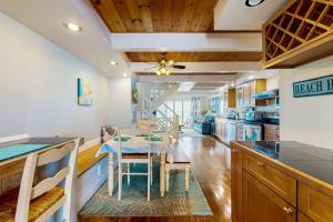 a kitchen with a table and a dining room at Ocean Colony 3 in Ocean City +17 photos