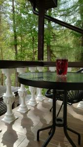 a glass sitting on top of a table on a porch at Rugpieniai in Jadagoniai