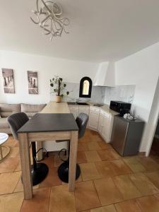 a kitchen with a table and chairs in a room at Maison Lou in Falicon