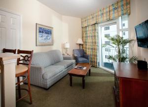a living room with a couch and a table at Holiday Sands at South Beach in Myrtle Beach
