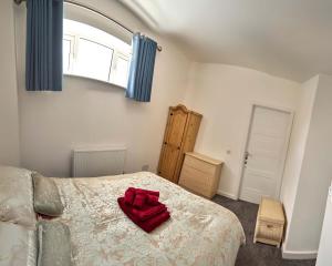 a bedroom with a bed with a red pillow on it at Iconic Apartment - Littleborough in Littleborough