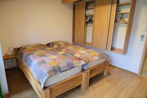 a bedroom with a bed and a wooden floor at Vinařská búda nad golfem in Skalica