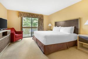 a bedroom with a large bed and a red chair at Fairway Forest in Sapphire +54 photos