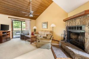 a living room with a couch and a fireplace at Fairway Forest in Sapphire