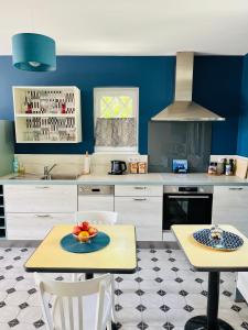 a kitchen with a table with a bowl of fruit on it at Orpheus Lodge in Giverny +23 photos