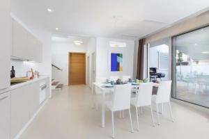 a kitchen and dining room with white tables and white chairs at Villa Vera in Novigrad Istria +13 photos