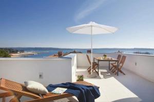 a patio with an umbrella and a table and chairs at Villa Vera in Novigrad Istria
