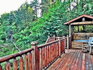 a wooden deck with a bench and a gazebo at Secluded Cabin Near Smoky Mountains. Hot Tub! Honeymoon! in Sevierville