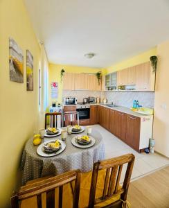 a kitchen with a table with plates of food on it at Апартамент “Централ” / Central in Balchik