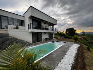a house with a swimming pool in front of it at Finca cerca a Panaca - Birdhouse85 in Alcalá