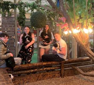 un gruppo di persone sedute su una panchina con i loro cani di Perfect Couple Retreat, Puppy Lounge & Games Room a Newton by Toft Altre 69 foto