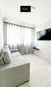 a living room with a couch and a window at Apartamento Jabotiana in Aracaju