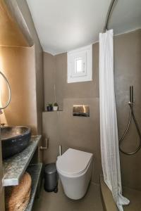 a bathroom with a toilet and a sink at Apopsis Tinos Square in Triandáros