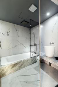 a bathroom with a tub and a toilet and a sink at Stay Hotel Gangnam in Seoul