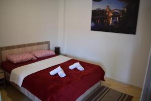 a bedroom with a bed with two towels on it at River Harmony Apartment in Mostar