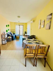 a living room with a table and chairs and a couch at Апартамент “Централ” / Central in Balchik +35 photos