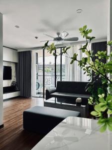 a living room with a couch and a table at Green Diamon Luxury Apartment in Ha Long