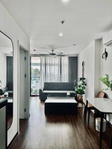 a living room with a couch and a table at Green Diamon Luxury Apartment in Ha Long