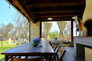 a dining room with a wooden table and chairs at Anna's House in Borgagne +50 photos