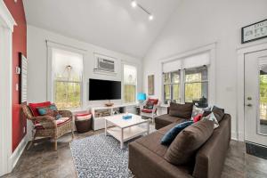 a living room with a couch and a tv at The Tree Frog - 12 Pine Forest in Cherry Valley