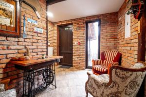 a room with a brick wall with a table and chairs at APARTMÁNY Prešov 1, Slovenska 92 - 1 in Prešov +3 photos