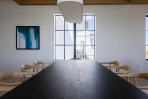a table in a room with chairs and windows at Waterfront Luxury Home - Tidelands House in Key West +50 photos