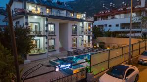 a building with a car parked in front of it at HONEY SUİTEs 1 in Fethiye